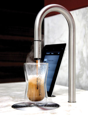 The polished TopBrewer swan-neck tap rising from a stone worktop above a concealed under-counter beverage system.